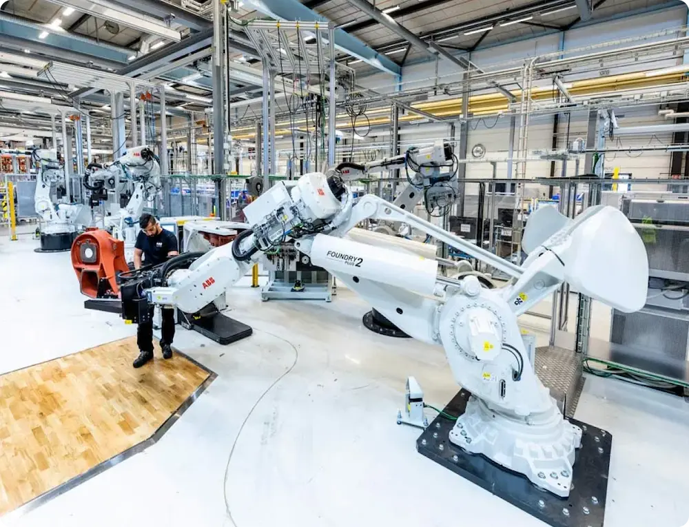 Technician working with a robot arm in modern industrial factory