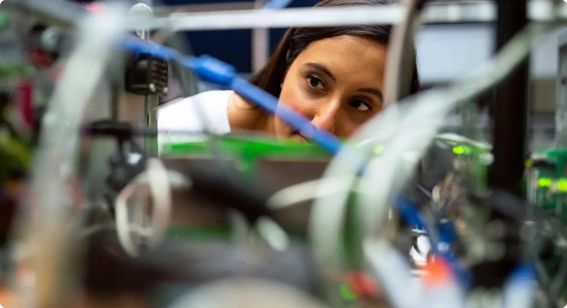 Close-up of woman looking at cables in an industrial environment