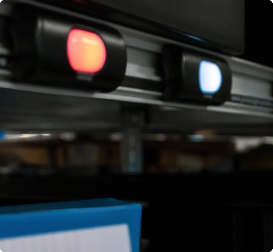 Close-up of Binar Pick to Light order picking system showing a blue and a red lamp
