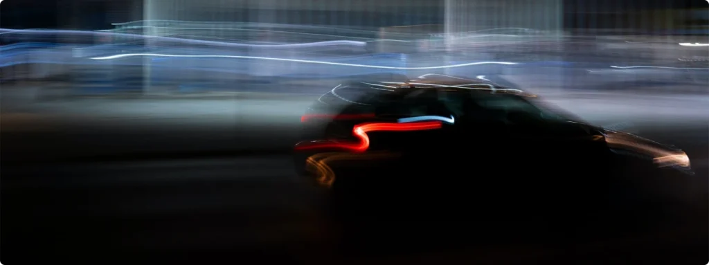 Dark image of a car driving fast