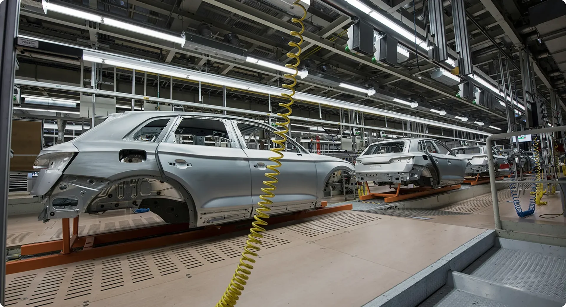 Automated car manufacturing line with unfinished vehicle bodies on the assembly line